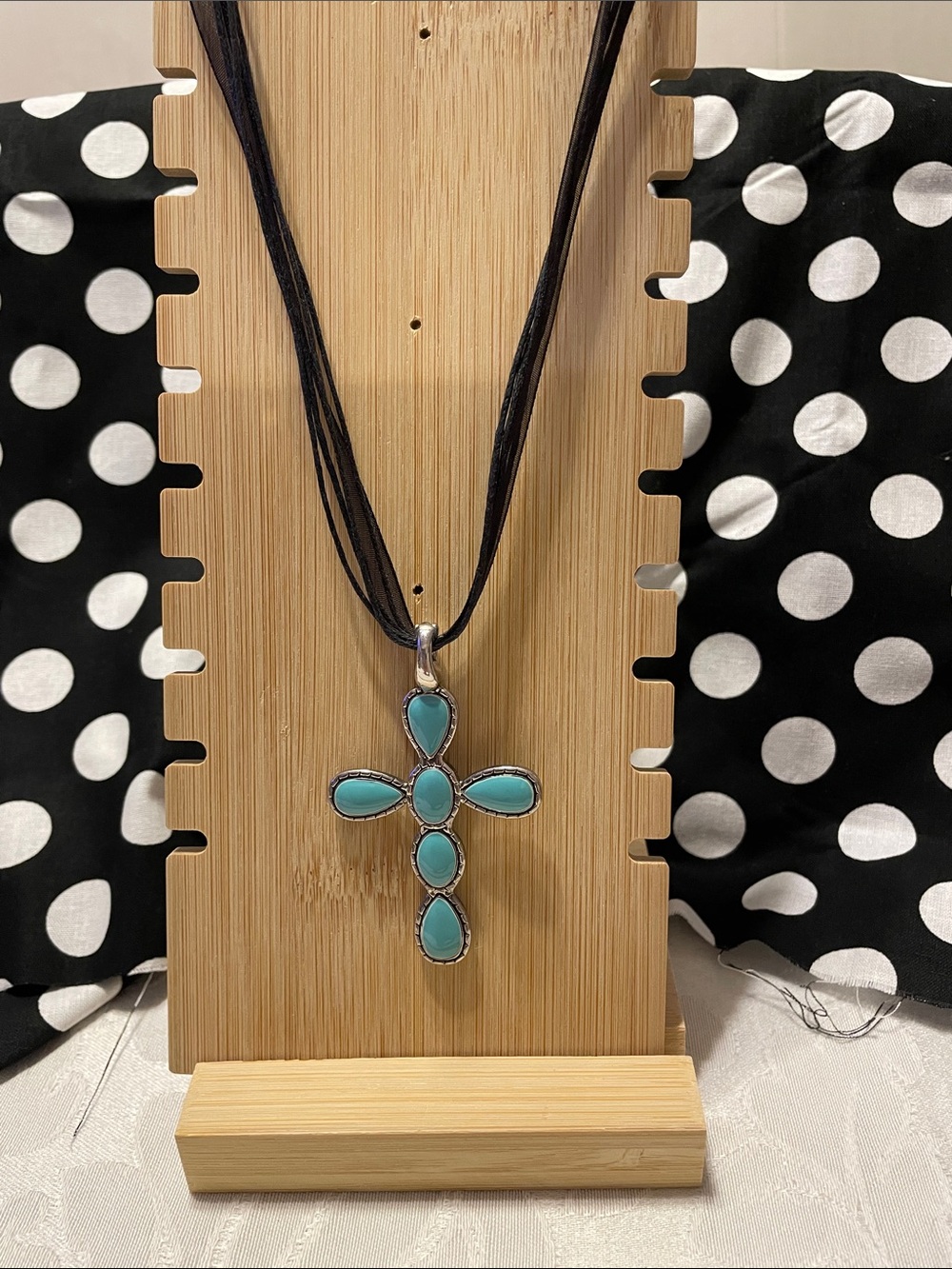 Double-sides cross pendant with multi strand necklace.